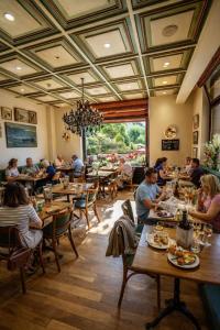 a group of people sitting at tables in a restaurant at Rivage Hotel Restaurant Lutry in Lausanne