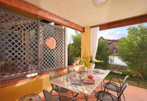a patio with a table and chairs on a deck at Borgo Del Torchio - Gardagate in Manerba del Garda