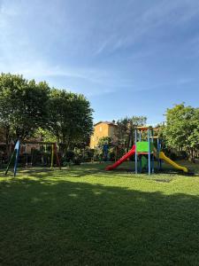 a playground with a slide in a park at Borgo Del Torchio - Gardagate in Manerba del Garda