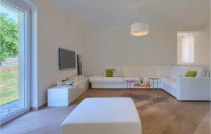a living room with a white couch and a table at Villa Hemera - Oasis of Peace and Privacy by Istrabook in Kršan