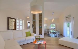a living room with a white couch and a table at Villa Hemera - Oasis of Peace and Privacy by Istrabook in Kršan