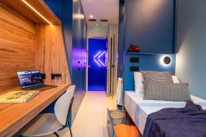 a bedroom with a bed and a desk with a laptop at La 15 Palmera Residence By Soho Boutique in Seville +10 photos