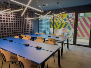 a group of tables and chairs in a room at La 15 Palmera Residence By Soho Boutique in Seville