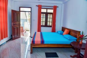 a bedroom with a bed and a window at Maiya Wild Ship Villa in Kosgoda