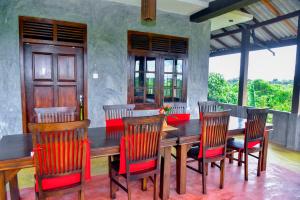 a dining room with a wooden table and chairs at Maiya Wild Ship Villa in Kosgoda +60 photos