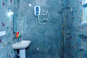a bathroom with a shower and a sink at Maiya Wild Ship Villa in Kosgoda