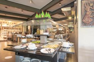 a restaurant kitchen with food on a buffet line at Oak Ray Regency in Kandy