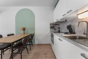 a kitchen with a wooden table and a dining room at Lilyta B201 in De Haan