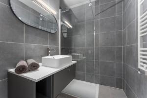 a bathroom with a sink and a mirror at Lilyta B201 in De Haan