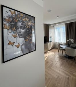 a living room with a painting of a woman at City Centre Apartment with Cathedral View, Self Check-in in Šiauliai +15 photos