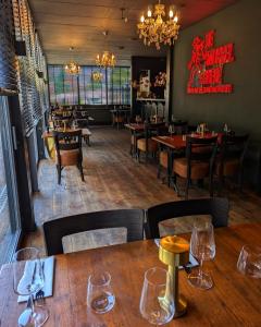 a restaurant with wooden tables and chairs and a dining room at De Smokkelhoeve in Riemst