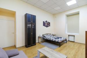 a living room with a bed and a table at Hostel in the center in Kyiv