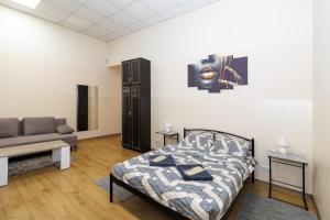 a bedroom with a bed and a couch at Hostel in the center in Kyiv