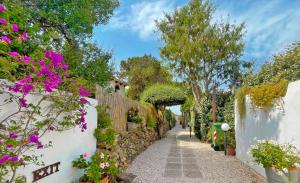 a garden path with flowers and a fence at Sea Love in Olbia