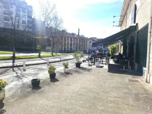 a patio with potted plants outside of a building at Pension y Apartamentos Txingurri Experience in Astigarraga