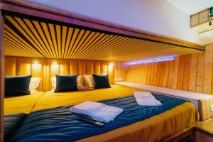 a bedroom with a bed with two towels on it at SLEEPBOAT Golden Life Yacth Oporto in Douro in Porto