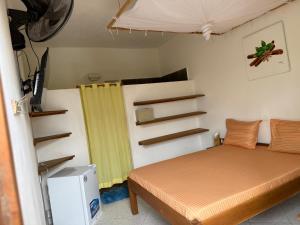 a bedroom with a bed and a yellow curtain at Villa Bella Vista in Hell-Ville