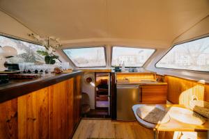a kitchen with a sink and a table in a van at SLEEPBOAT Golden Life Yacth Oporto in Douro in Porto