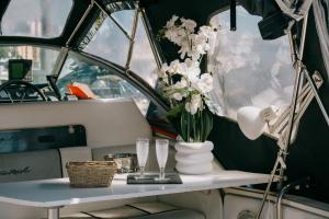 a table with a vase of flowers on a boat at SLEEPBOAT YACHT in Oporto Douro in Porto +28 photos