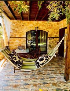 a hammock on a patio of a house at Villa Aggeliki in Prinos