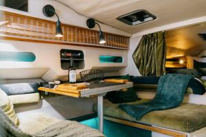 a living room with a table in a trailer at SLEEPBOAT YACHT in Oporto Douro in Porto