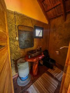a small bathroom with a sink and a mirror at Zambeze Lodge in Marracuene +48 photos