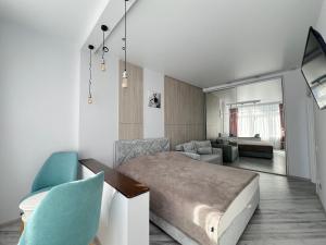 a bedroom with a bed and a living room at Delicious Aparts in Odesa