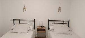 two beds sitting next to each other in a bedroom at Camposa2025 in Muxia