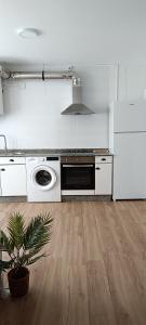 a white kitchen with a stove and a dishwasher at Camposa2025 in Muxia