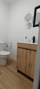 a bathroom with a toilet and a sink and mirrors at Camposa2025 in Muxia