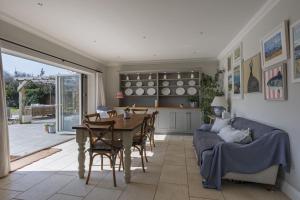 a kitchen and dining room with a table and a couch at Appletree House in Sway