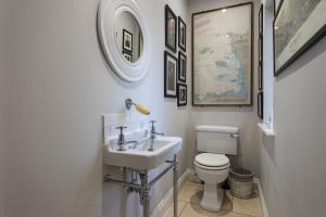 a white bathroom with a sink and a toilet at Appletree House in Sway +92 photos