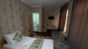 a hotel room with a bed and a bathroom at Alisher hotel in Samarkand