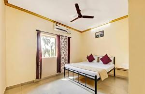 a bedroom with a bed and a window at SAI GUEST house in Calangute