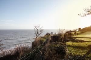 a fence on a hill next to the ocean at Sea Marge Hotel in Overstrand +44 photos