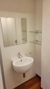 a bathroom with a white sink and a mirror at Appartamenti Ariston - Centro Giulianova in Giulianova +2 photos