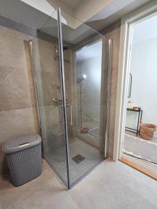 a shower with a glass door in a bathroom at GHAR-New 2 bedrooms apartment near airport and Oslo city-free parking in Klofta +28 photos