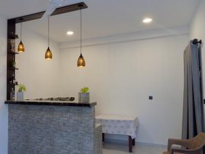a living room with a table and pendant lights at Blue Cinnamon Cove in Kosgoda +26 photos