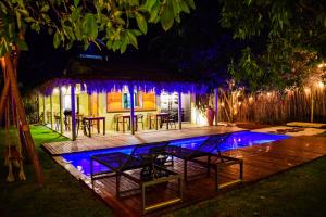 a house with a swimming pool at night at Pousada Noah Noah Milagres in São Miguel dos Milagres +98 photos