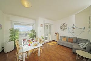 a living room with a table and a couch at Petronella - Gardagate in Soiano del Lago