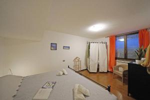 a bedroom with a bed and a large window at Petronella - Gardagate in Soiano del Lago +32 photos