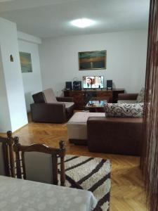 a living room with a couch and a chair at Apartment TiBi in Kumanovo