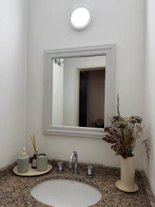 a bathroom with a sink and a mirror at Los Recoletos in Villa Mercedes +3 photos