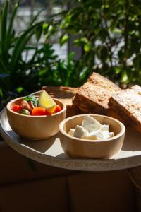 two bowls of food on a plate with bread at Terra Boutique Hotel in Tirana