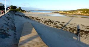a beach with a boardwalk leading down to the beach at Camposa2025 in Muxia