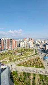 a view of a city with buildings and a park at Parkside Dighomi in Tbilisi City
