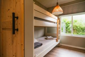 a bunk bed in a room with a window at Frafjord Apartments Thor in Dirdal