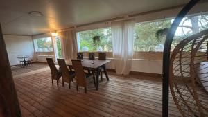 a dining room with a table and chairs and windows at Villa Ekbladh in Västanfjärd