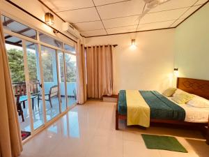 a bedroom with a bed and a balcony at KVA Talalla Beach Villa in Talalla South