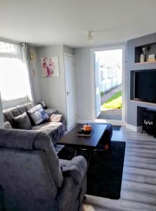 a living room with a couch and a table at The Marylyn in Mablethorpe